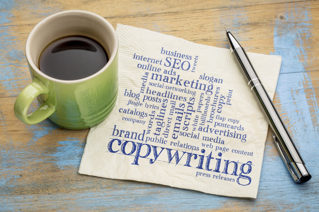 coffee, pen, and text on a napkin reads "copywriting" - article about working with a website content writer