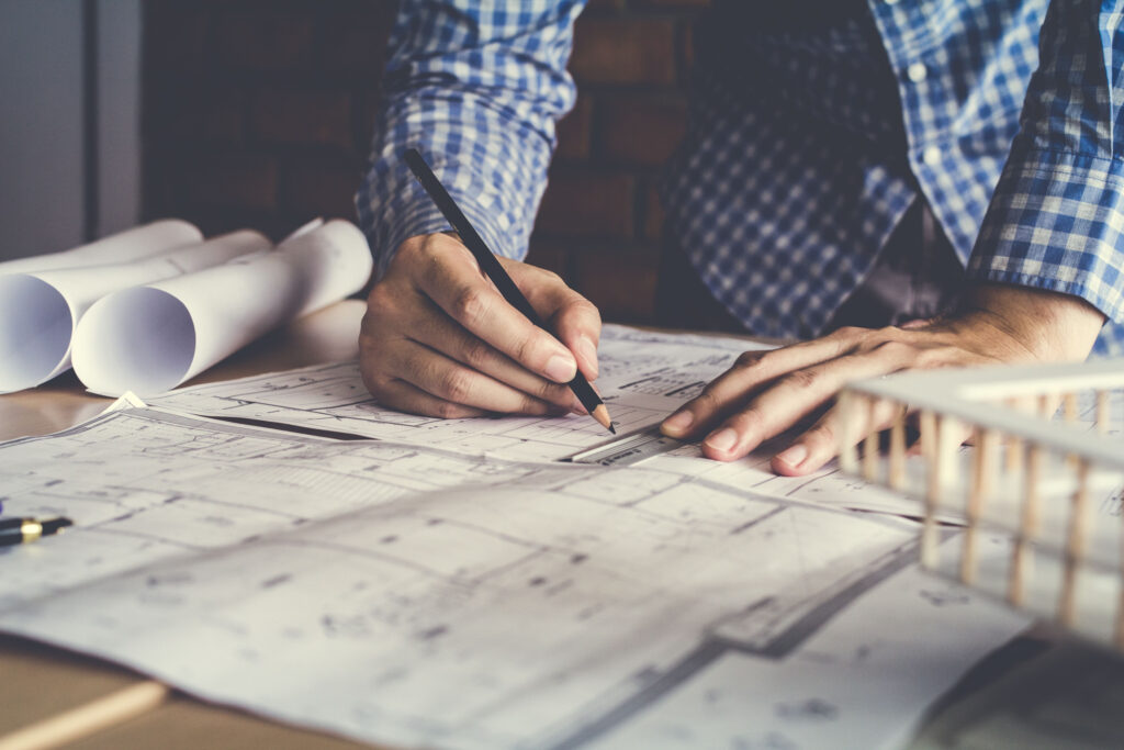architect drawing blueprints like a digital content strategist planning content