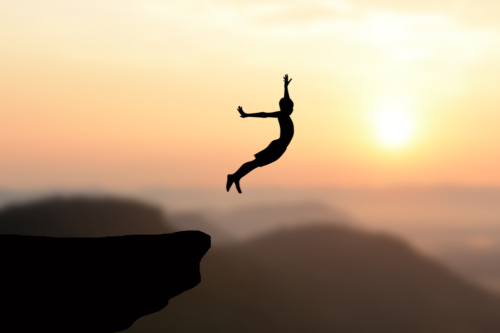 boy jumping off a cliff to symbolize creative digital marketing